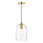 Clear glass pendant light above table with warm bulb