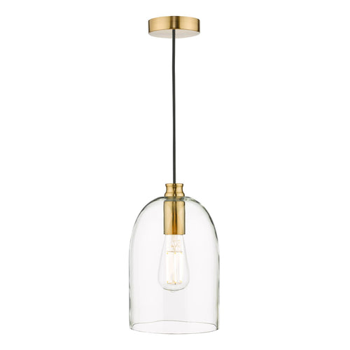 Clear glass pendant light above table with warm bulb