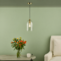 Glass pendant light with satin bronze fitting in interior