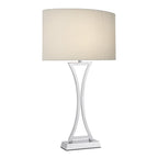 Chrome table lamp with cream fabric shade on white background