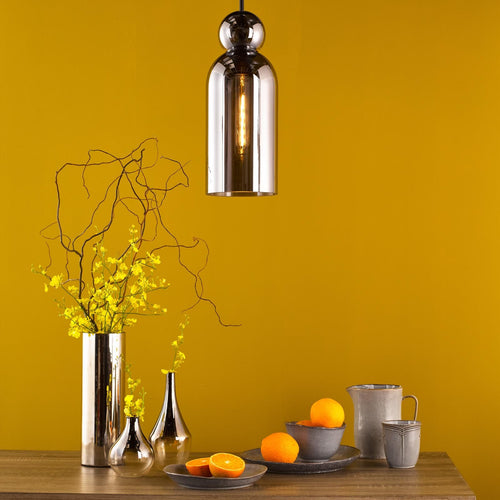 Smoked glass pendant light in modern kitchen setting with decor