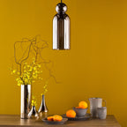 Smoked glass pendant light in modern kitchen setting with decor