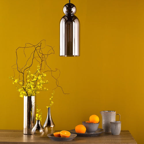 Smoked glass pendant light in modern kitchen setting with decor