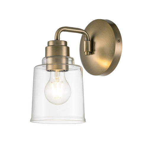 Aivian wall sconce in brushed brass with clear cylindrical shade, unlit bulb visible